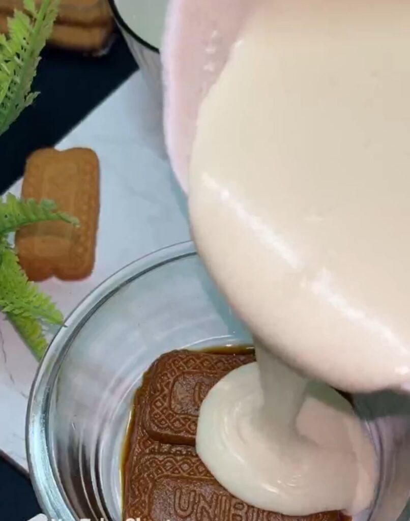 Layering ladyfingers and cream for tiramisu dessert recipe