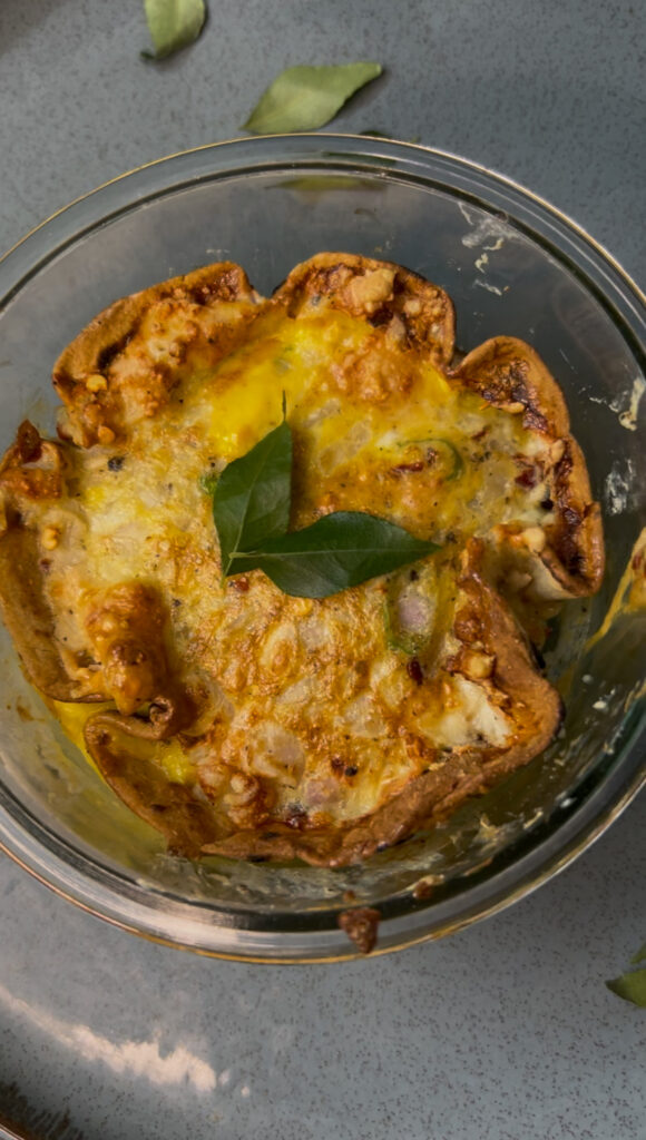 Fluffy easy breakfast omelet served on a white plate with herbs