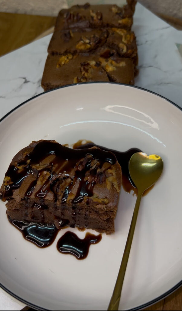 Rich and moist chocolate cake slice on a white plate