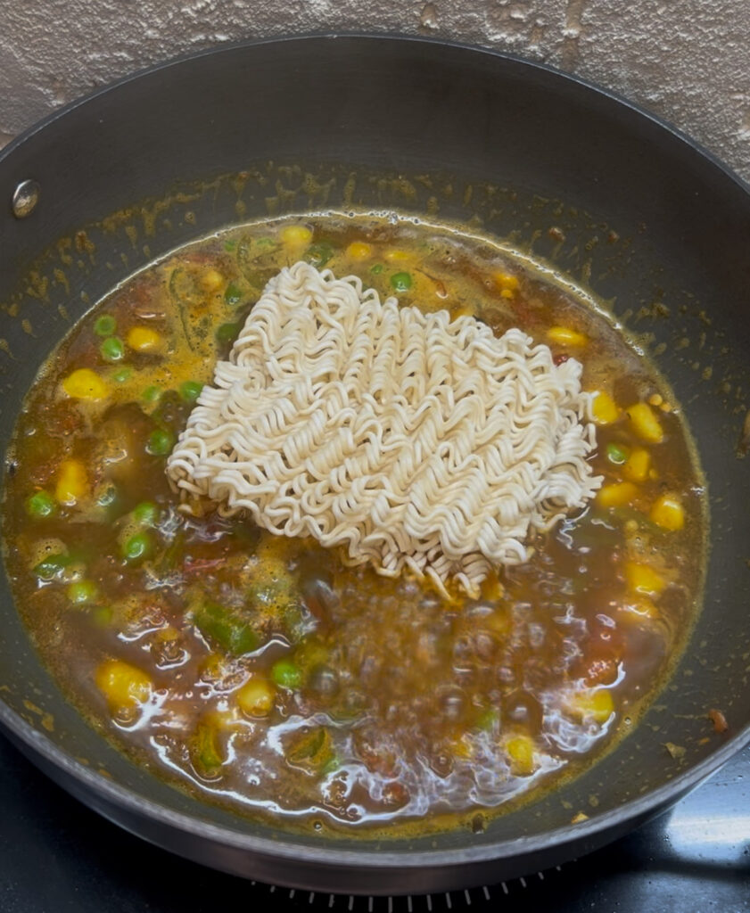 Close-up shot of spicy vegetable noodles in a white ceramic bowl