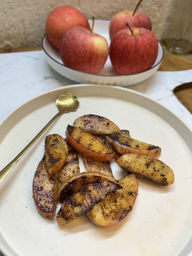 Freshly baked apple pie with cinnamon on a rustic wooden table
