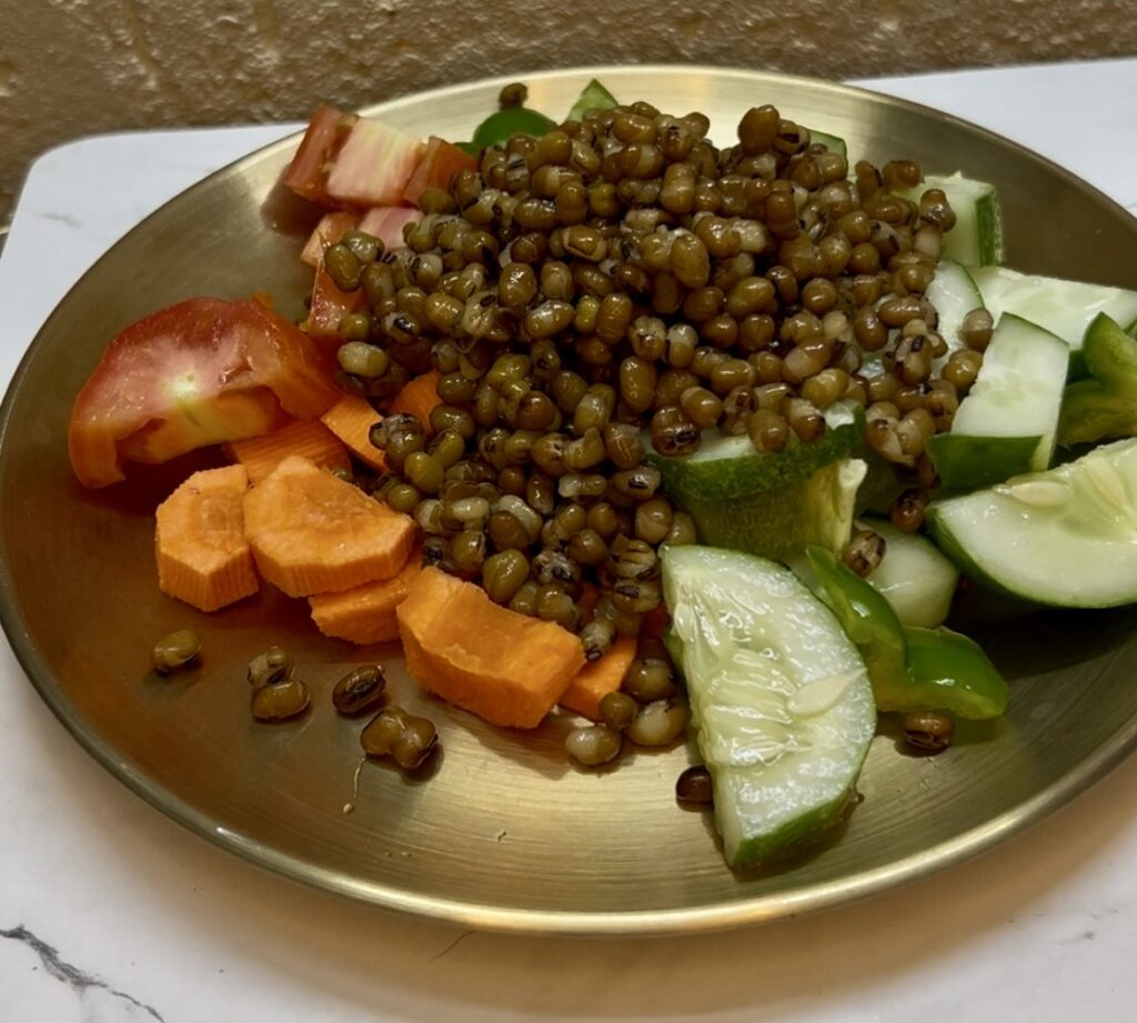 Raw green gram in a wooden spoon on a rustic table