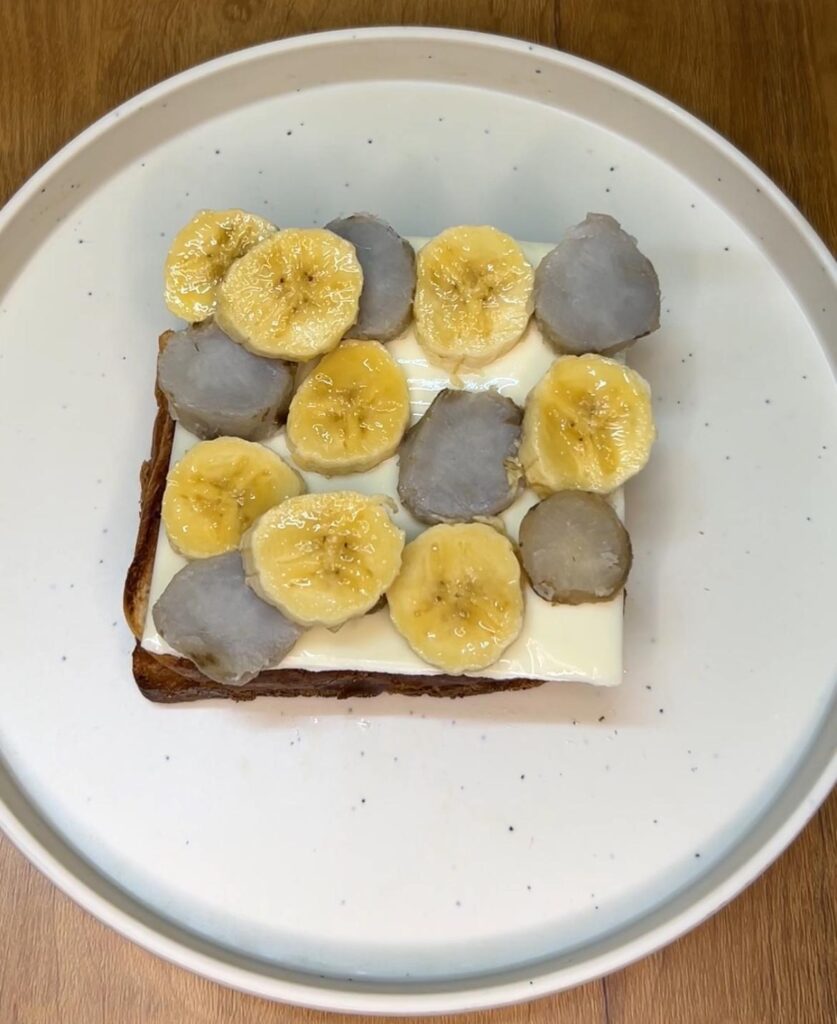 Top view of honey being drizzled over sliced bananas on toast
