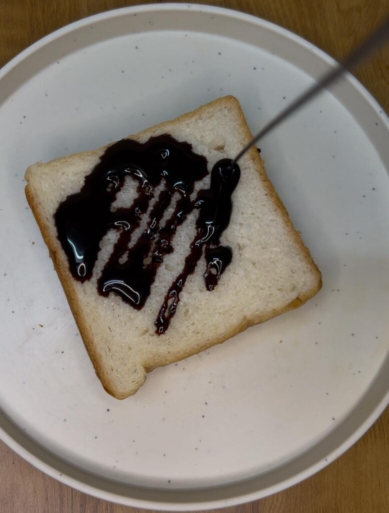 Stack of crispy toasted chocolate sandwiches on a white plate