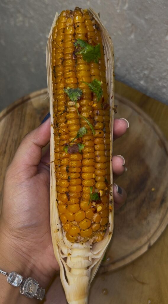 Freshly cooked air fryer corn on the cob served with melted butter