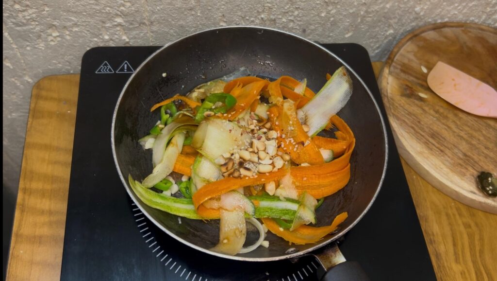 Freshly prepared Asian-style cucumber noodle salad with green onions