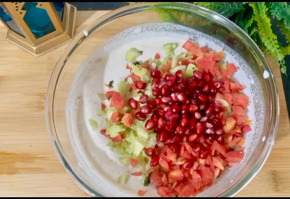 Greek yogurt salad served with pita bread and lemon wedges