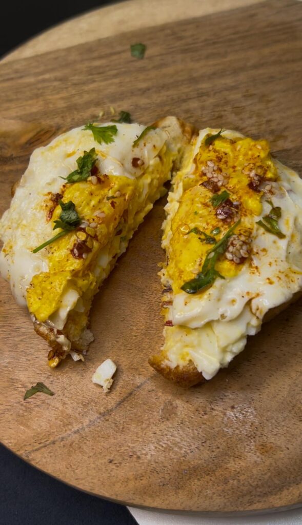 Colorful scrambled egg toasts with toppings like spinach, feta, and tomatoes