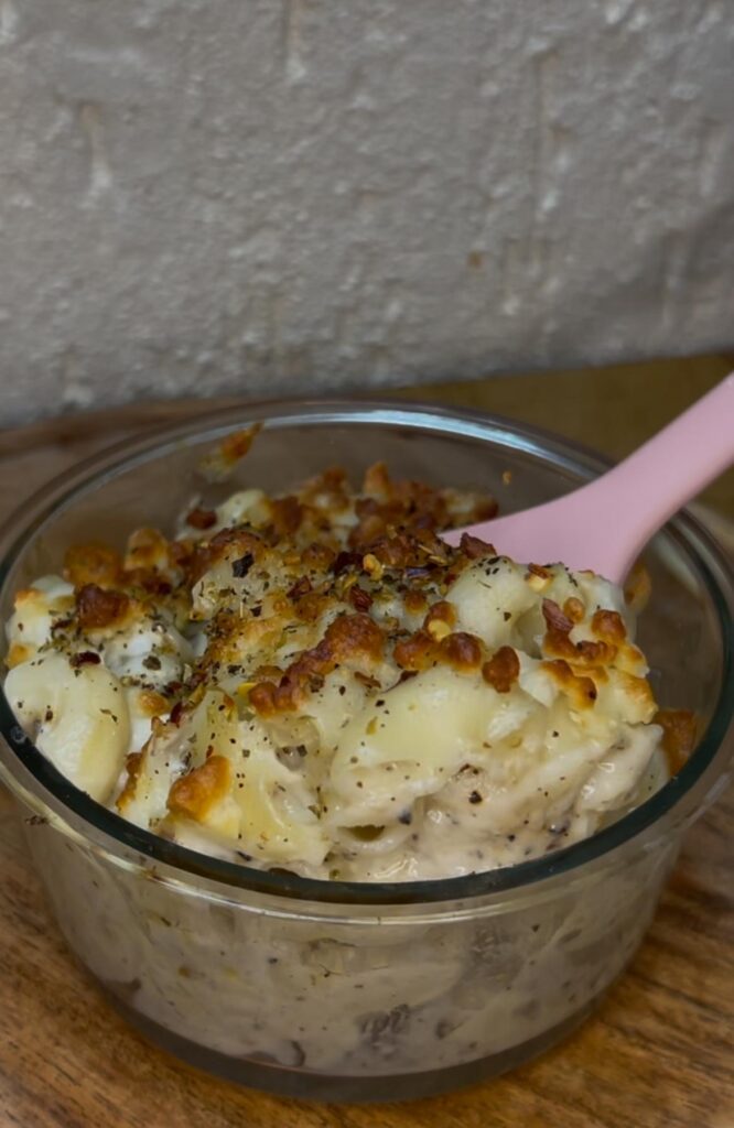 Golden baked mac and cheese in a white casserole dish