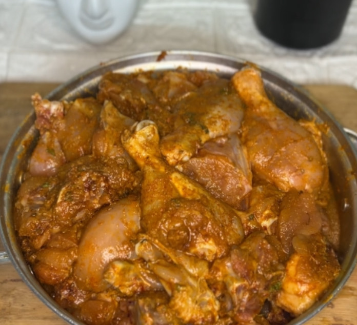Rich, buttery tomato sauce simmering with marinated chicken