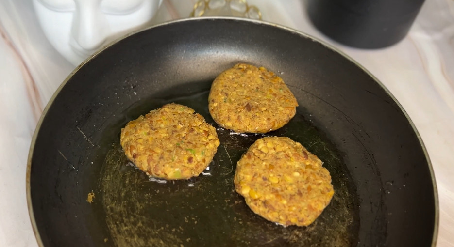 Healthy chickpea cutlet burger stacked with veggies and sauce