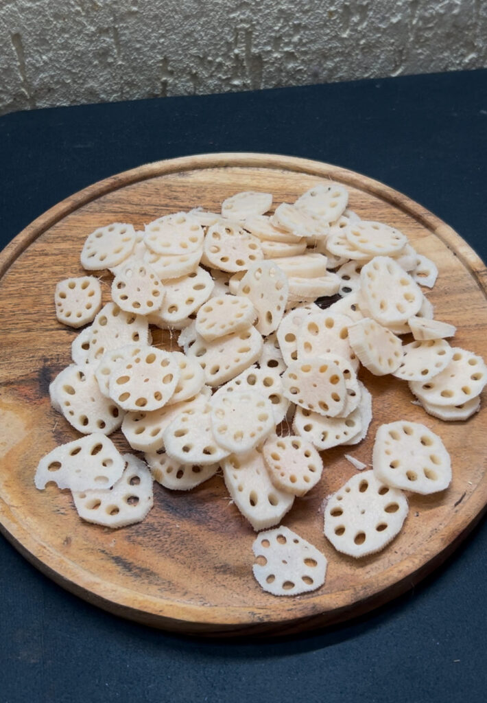 Crispy lotus stem stir-fry served in a white bowl