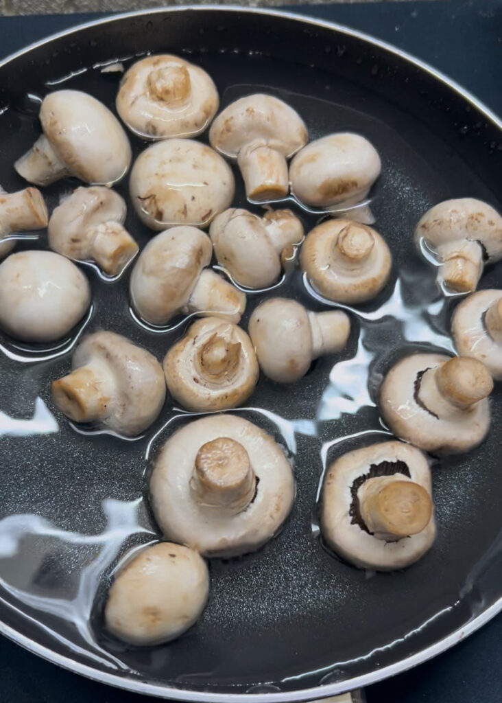 Golden sautéed mushrooms in a rich, creamy sauce served with fresh bread