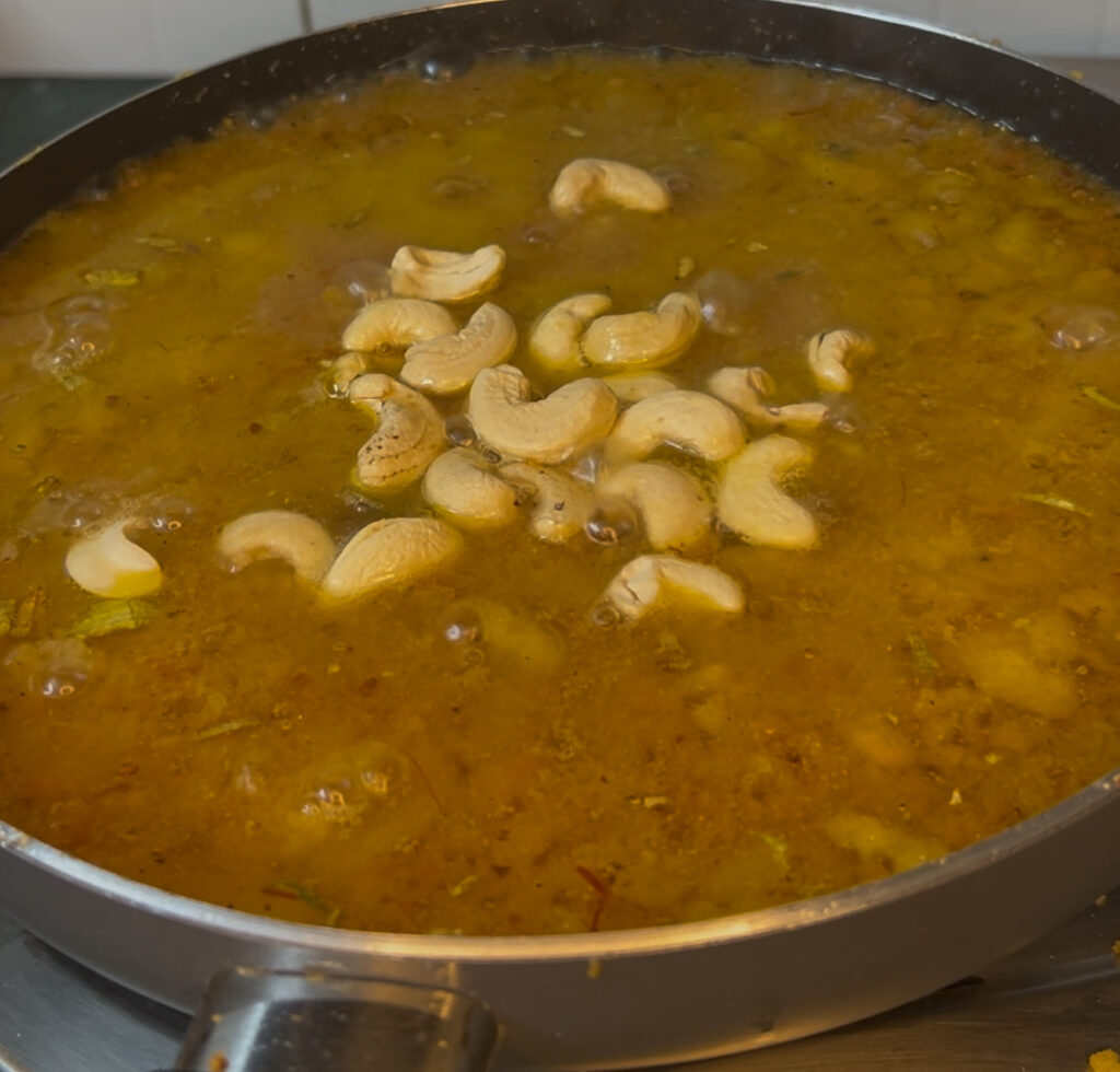 Bowl of creamy yellow lentil soup with fresh herbs


