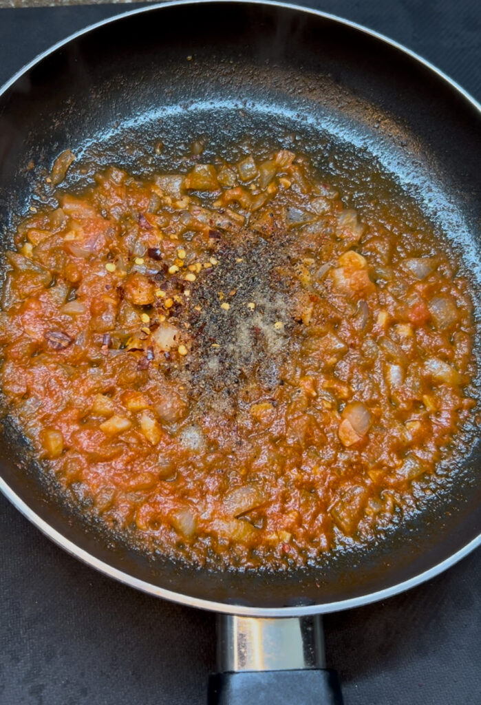 Delicious homemade red sauce pasta recipe with cheese topping