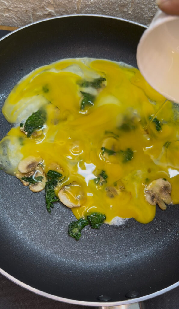 Simple spinach omelette garnished with fresh herbs