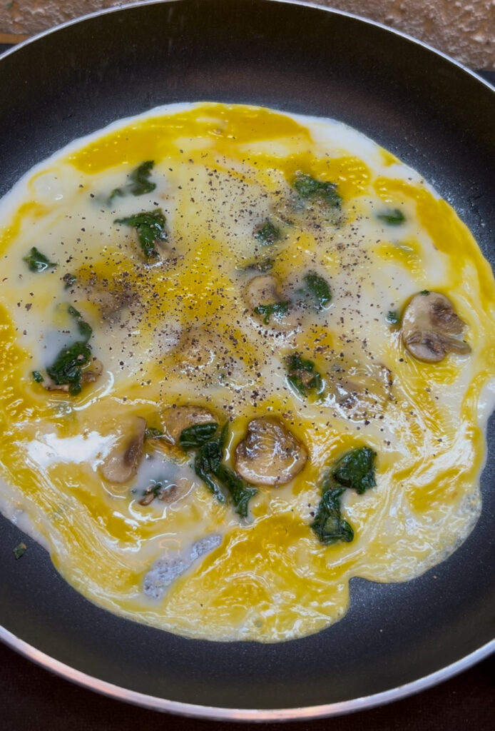 Simple spinach omelette garnished with fresh herbs