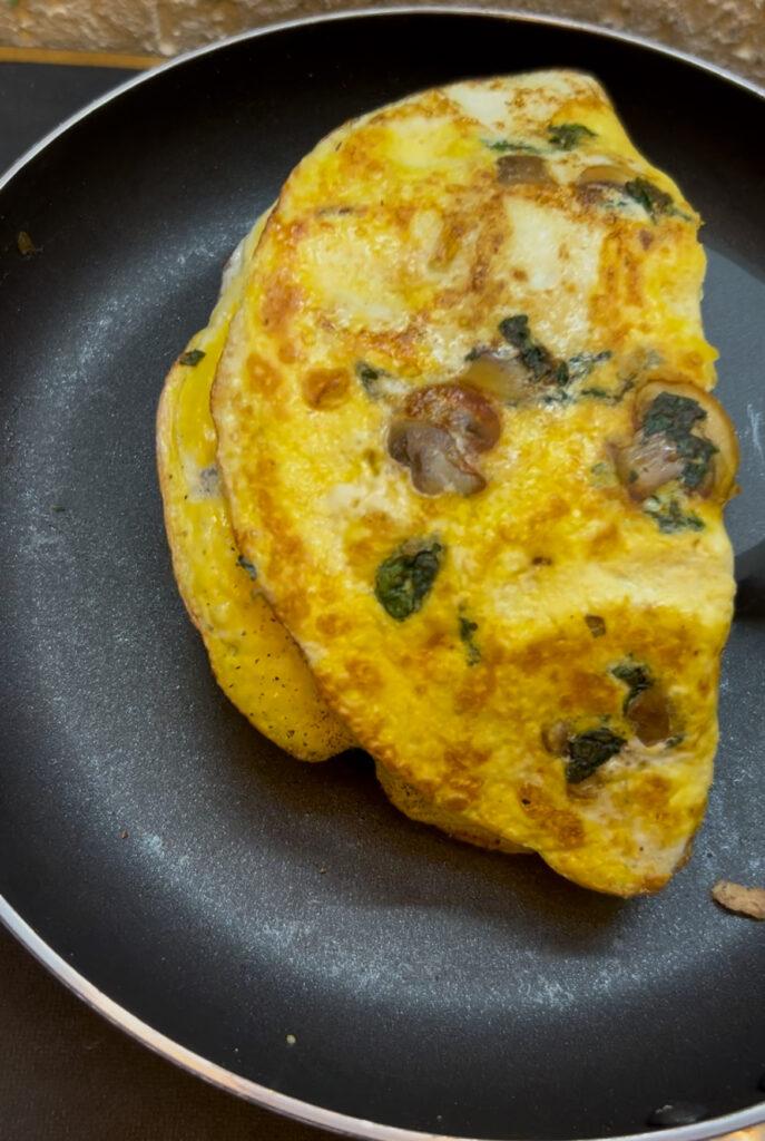 Spinach omelette breakfast with avocado and coffee