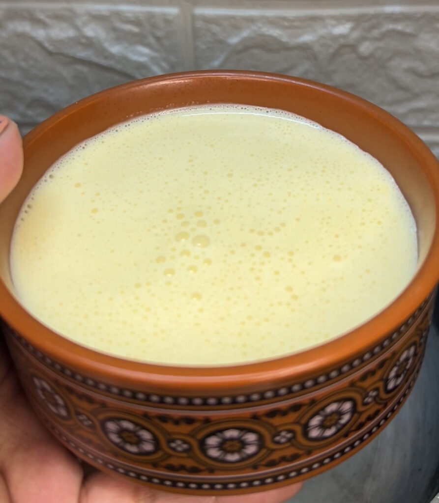 Close-up of creamy yogurt curry with fresh herbs