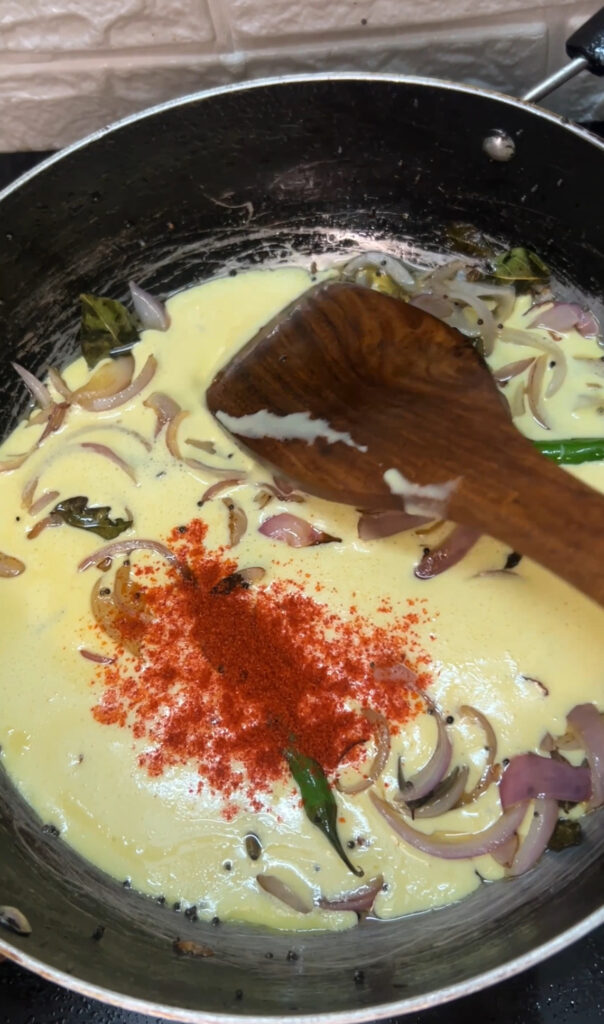 Healthy yogurt curry in a pan with turmeric and cumin