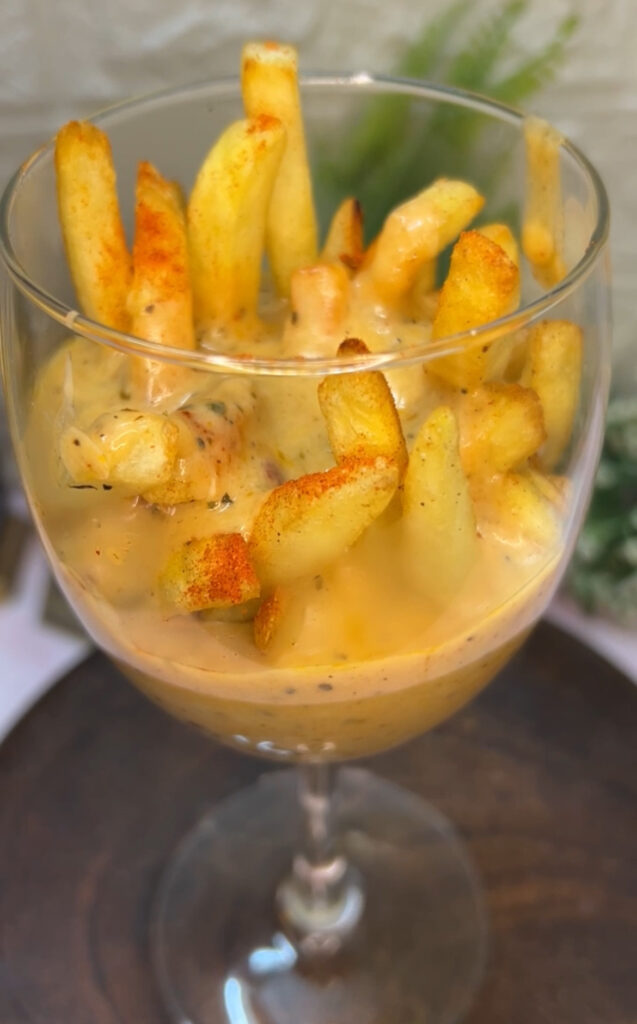 Delicious crispy fries covered in cheese sauce and toppings