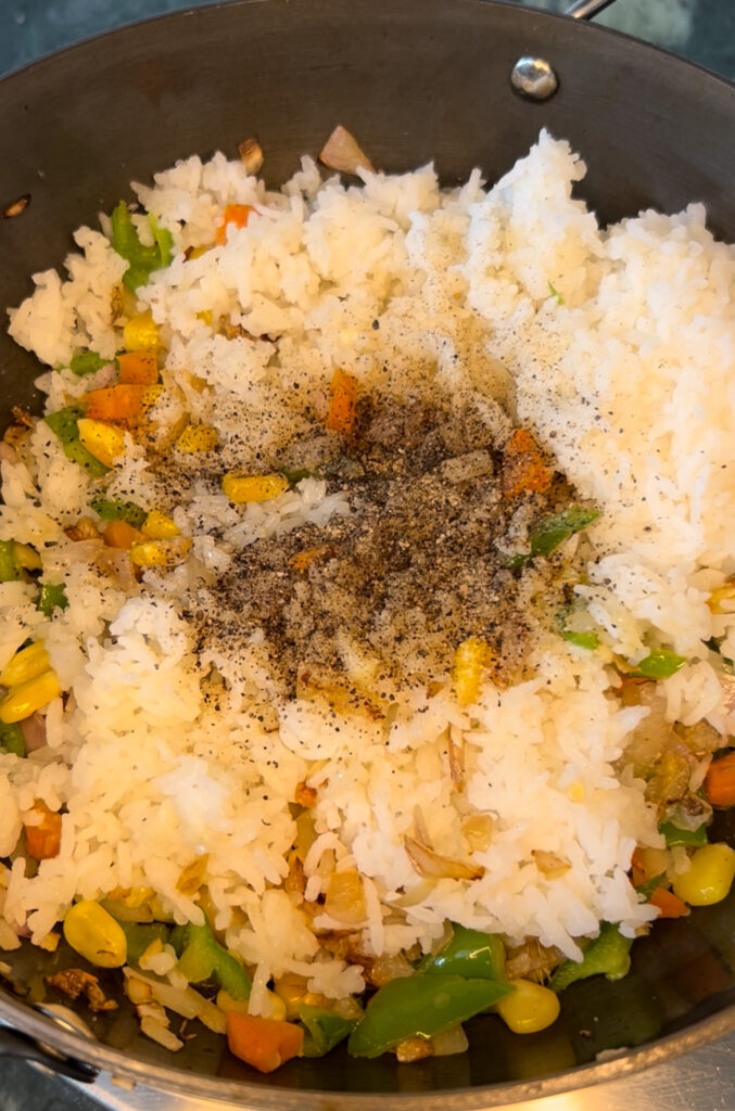 Bowl of nutritious vegetable rice garnished with coriander leaves