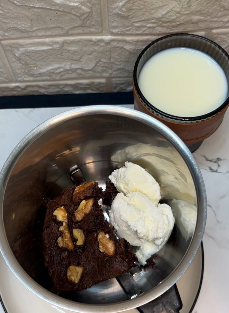 Thick brownie milkshake served with brownie chunks and sprinkles