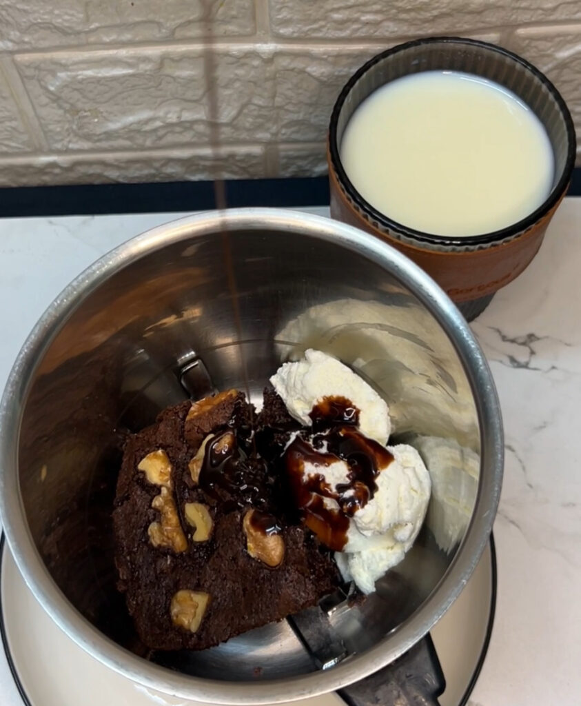 Chocolate brownie milkshake in a mason jar with straw
