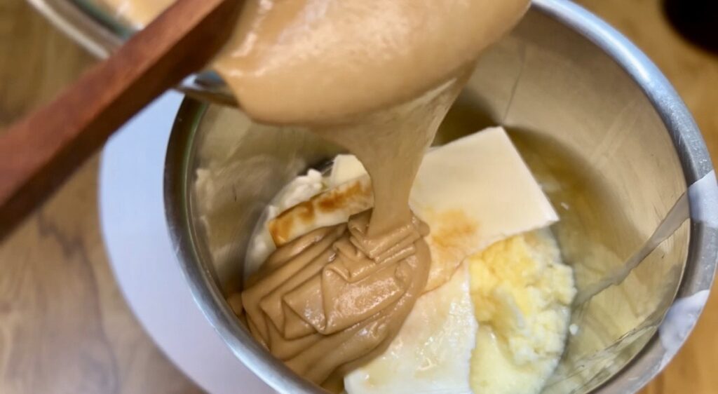 Slice of creamy cheesecake recipe served with whipped cream