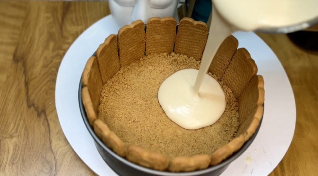 Slice of creamy cheesecake recipe served with whipped cream