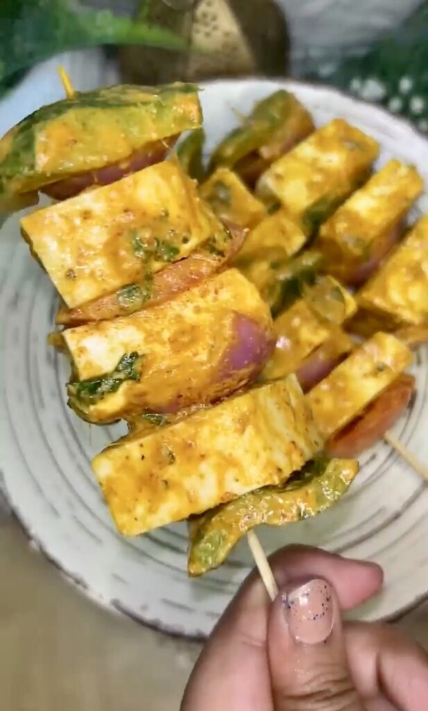 Air fryer tofu bites on a plate with vegetables