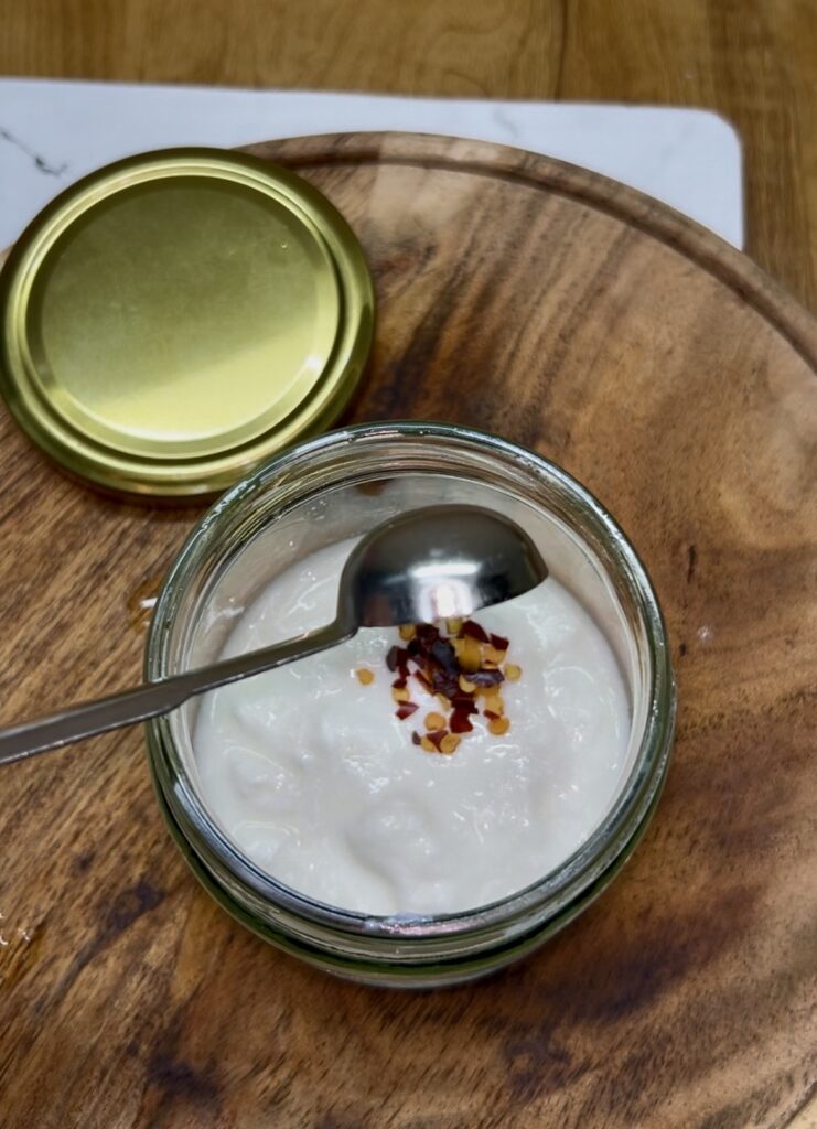 Close-up of creamy cucumber salad with herbs and sliced cucumbers