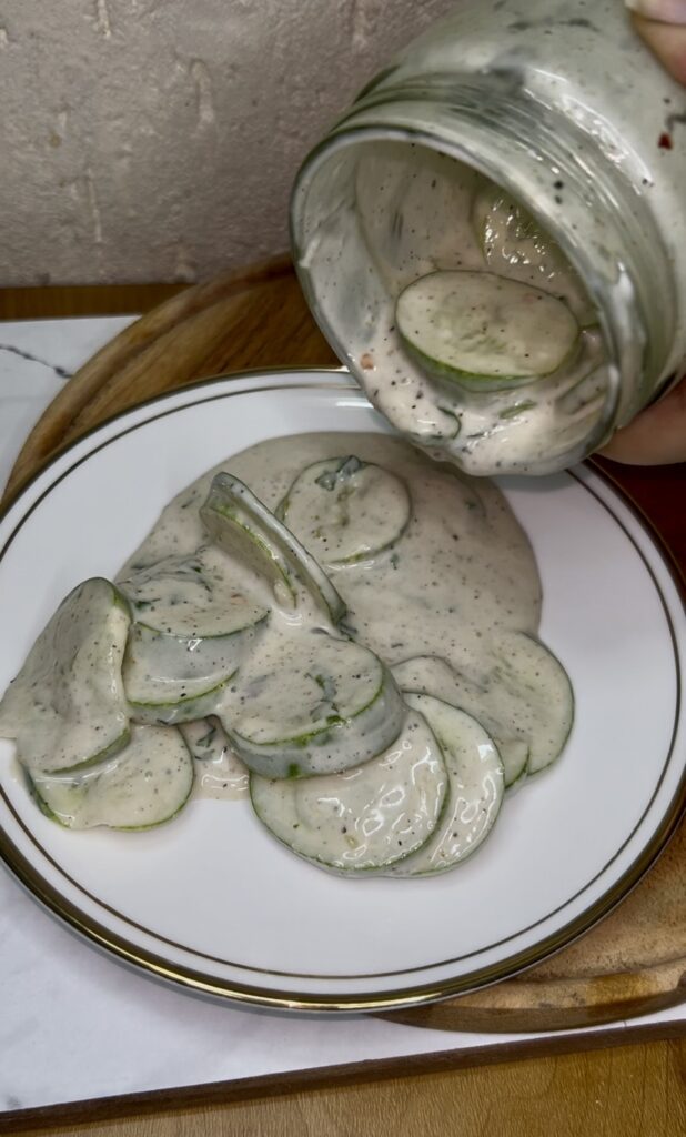 Homemade creamy cucumber salad garnished with parsley and onion