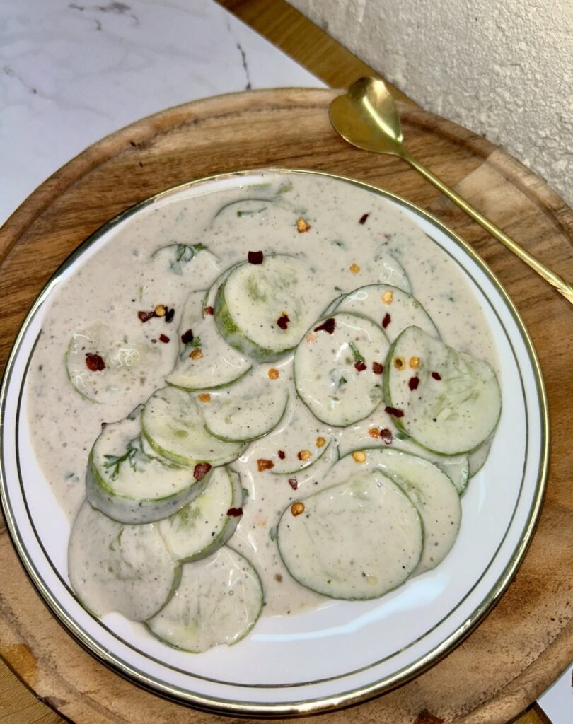 Bowl of creamy cucumber salad with fresh dill and yogurt dressing