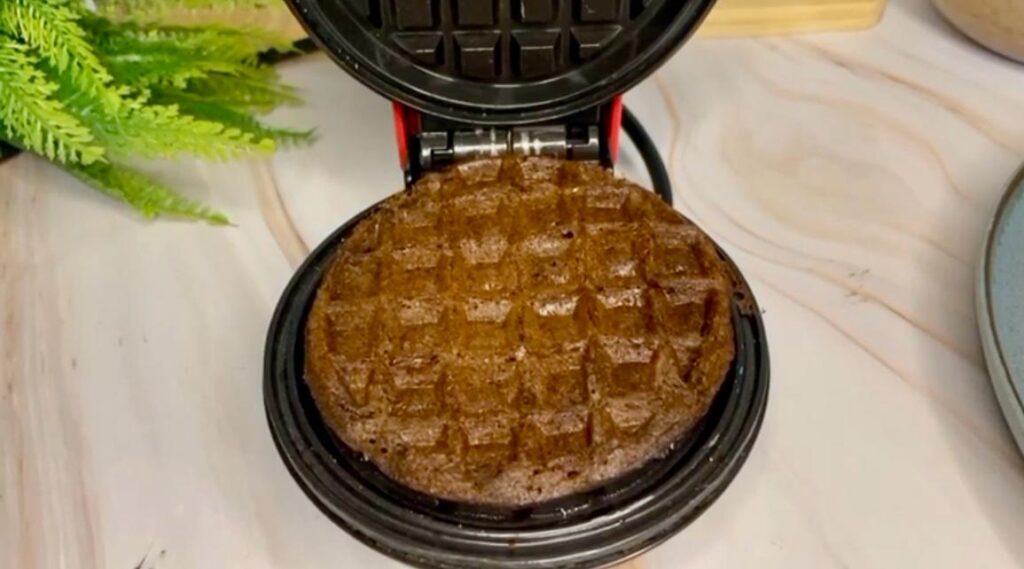 Homemade Belgian waffles on a breakfast table with a cup of coffee