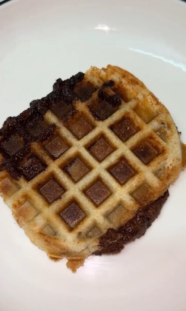 Classic Belgian waffle recipe on a white plate with honey drizzle