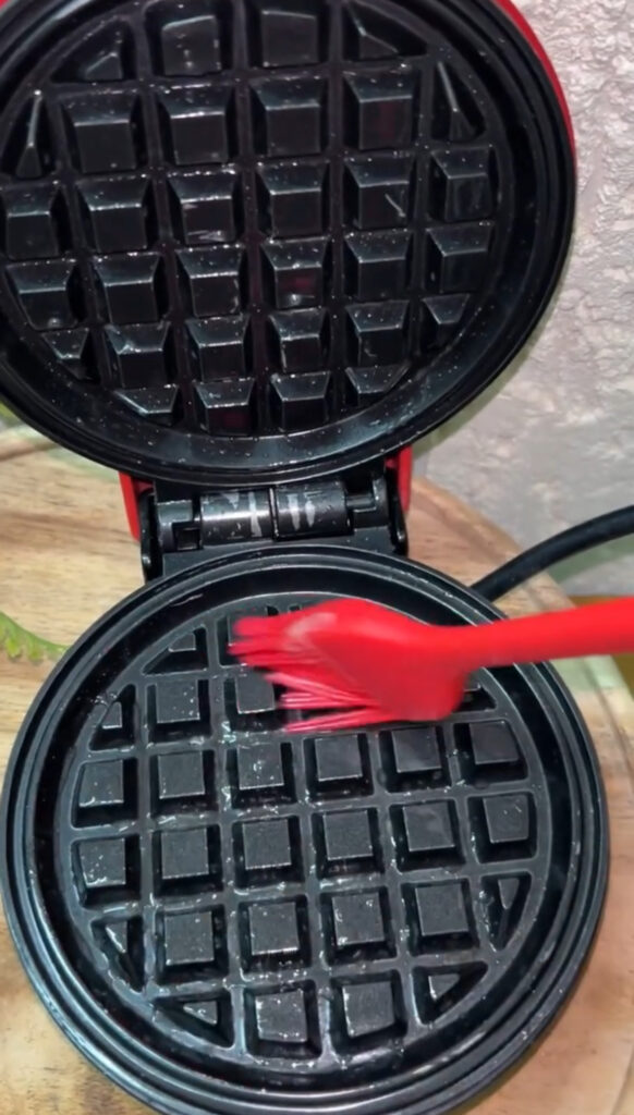 Easy waffle recipe served with whipped cream and strawberries
