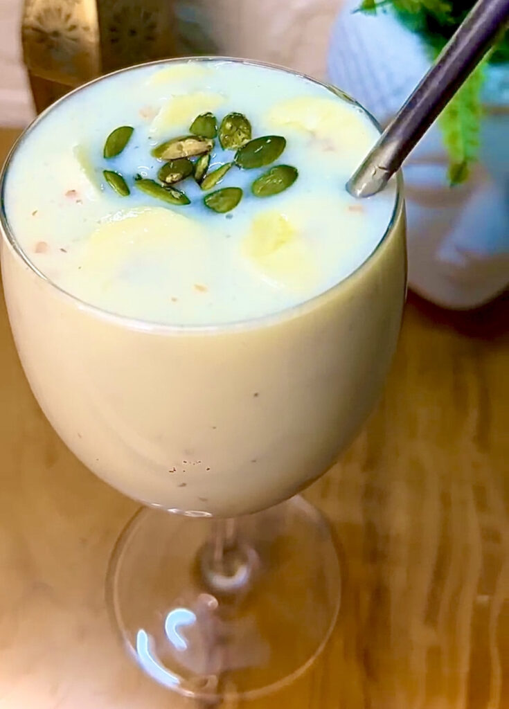 Healthy banana milkshake served with whipped cream and nuts