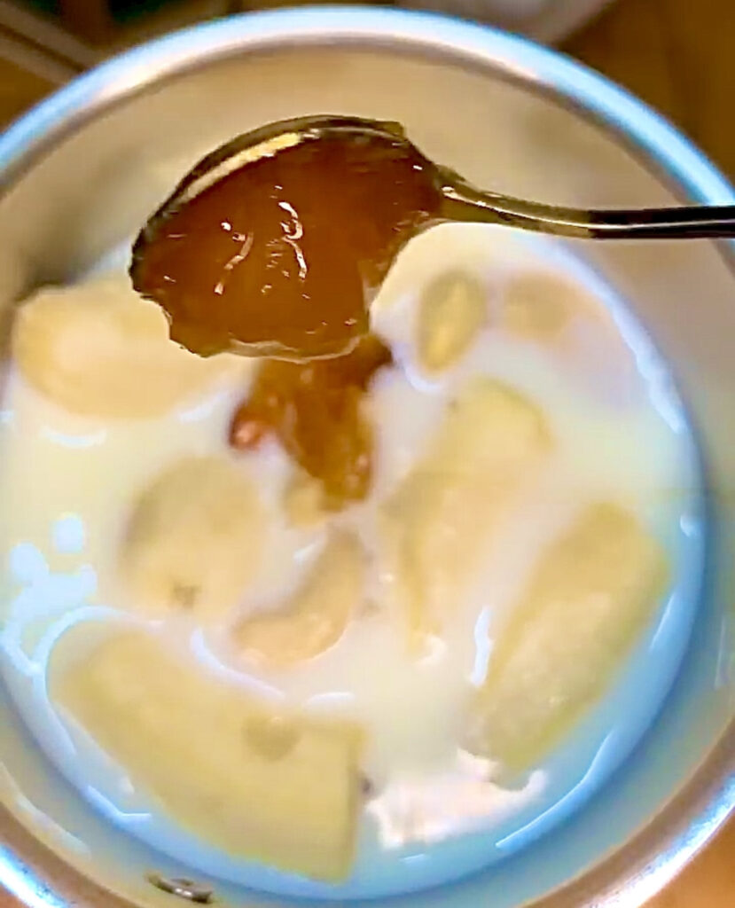 Healthy banana milkshake served with whipped cream and nuts