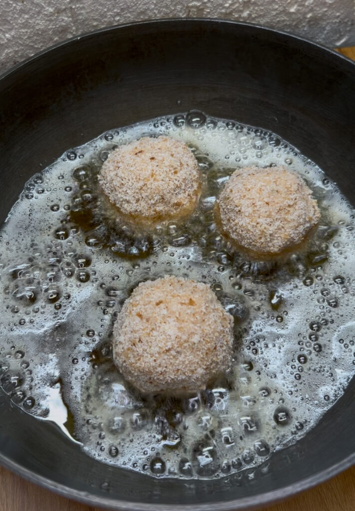 Easy homemade cheese balls garnished with fresh herbs