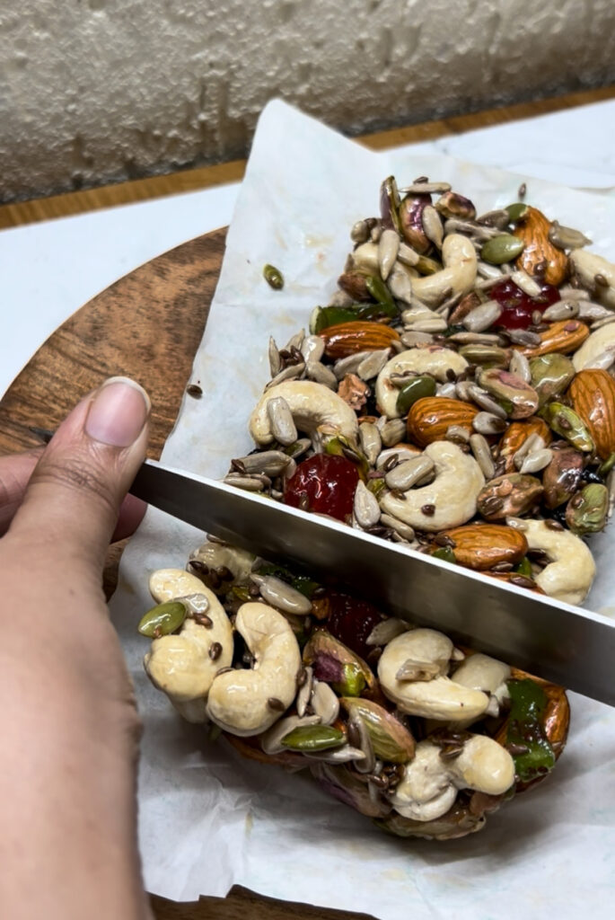 Granola bars with dried fruits and seeds on parchment paper