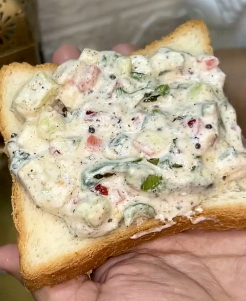 Close-up of creamy yogurt sandwich with fresh greens