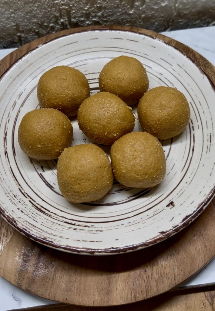 Close-up of homemade besan ladoo garnished with pistachios
