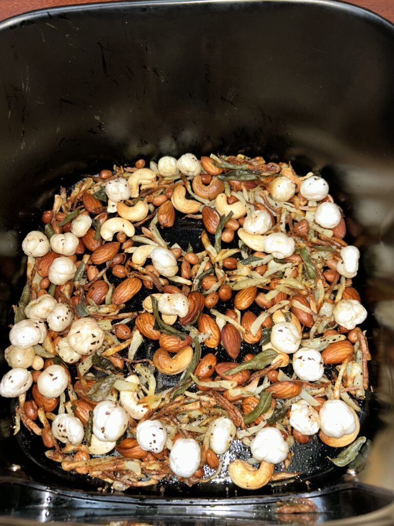 Close-up of a bowl filled with colorful homemade trail mix with nuts and dried fruits